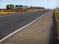A train and a straight stretch of road