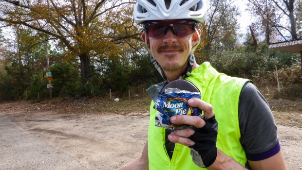 A bicyclist holds up a Moon Pie