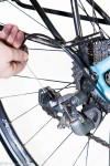 Hand threading cable through rear derailleur on a bicycle