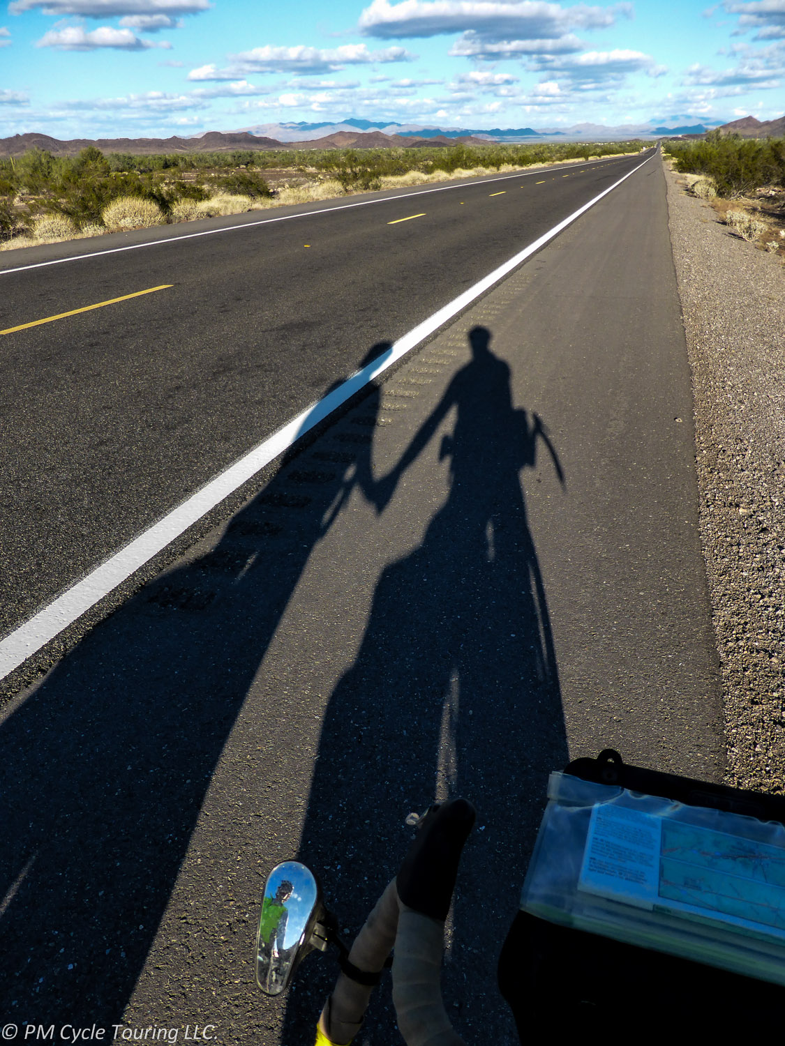 Shadows of Pam & Matt on a road outside Hope Arizona.