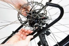 Removing the wheel from the bike by unscrewing the quick release skewers