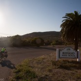A bike rider rides into Refugio State Beach