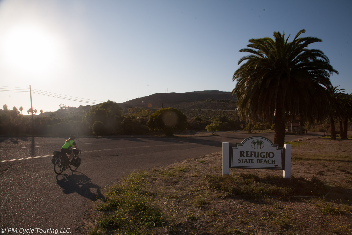A bike rider rides into Refugio State Beach