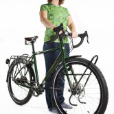 A woman stands with her Co-motion touring bicycle