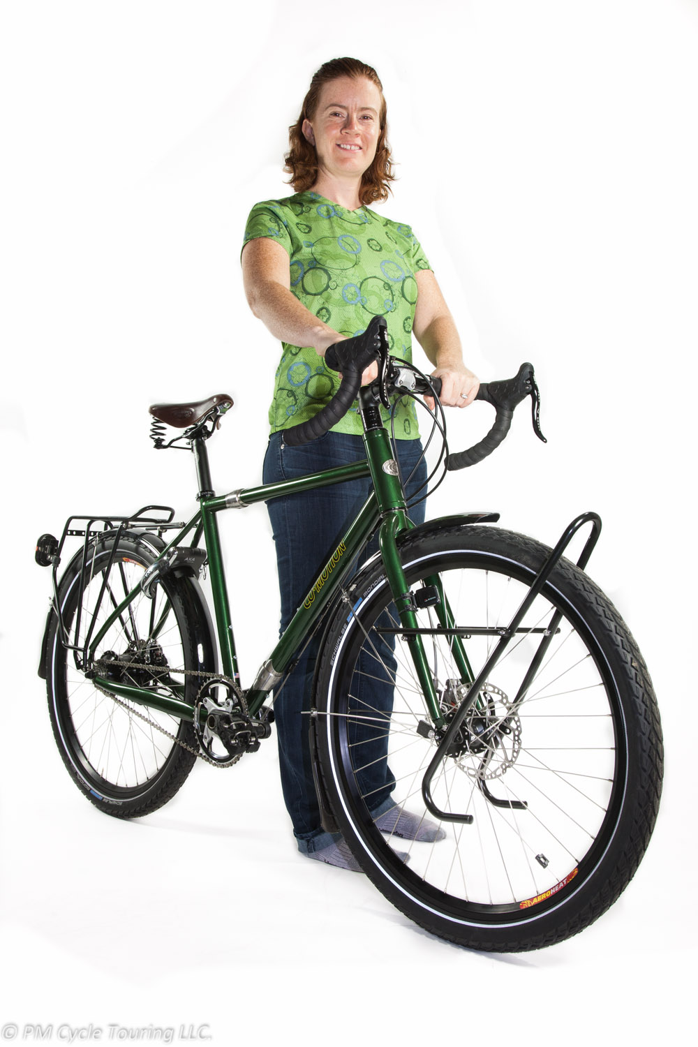 A woman stands with her Co-motion touring bicycle